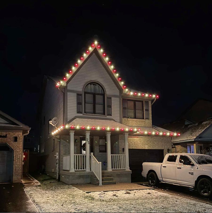 Two-storey home with crisp warm-white permanent roofline lighting in the evening